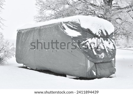 Snow on a recreational vehicle protective cover Royalty-Free Stock Photo #2411894439