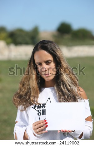 Portrait of a beautiful woman holding a white card