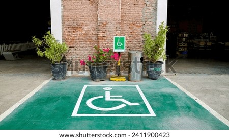 Outdoor car parking with handicap symbol icon. Parking space reserved for disability.