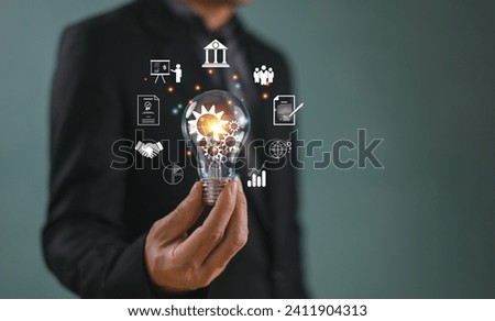 Businessman hand on light bulb, computer big data icon. Business global internet network application technology, digital marketing tech. Financial banking, Internet solution connection idea concept