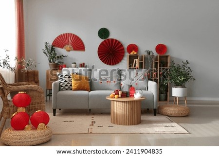 Interior of festive living room decorated for Chinese New Year celebration Royalty-Free Stock Photo #2411904835