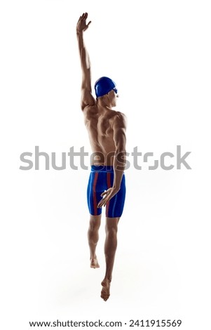 Athletic young man with muscular, relief, sportive body, male swimmer practicing swimming techniques over white background. Concept of water sports, championship, tournament. Sport event ad