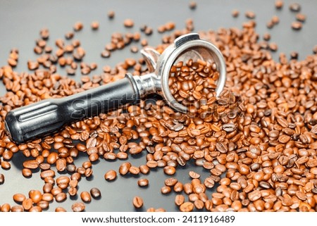 Coffee beans spread on the portafilter,concept pictures closeup with coffee beans and equipment of cafe coffee shops.