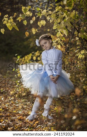 Little ballerina in autumn park