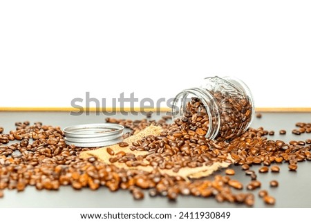Coffee beans spread out of bottles and put on sack with closeup concept picture.