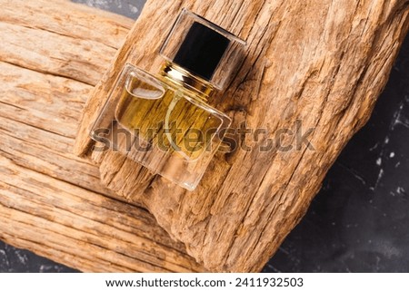 Perfume bottle mockup on old wood, on textured black background