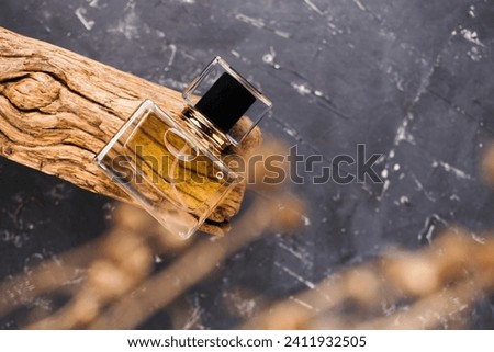 Perfume bottle mockup on old wood, on textured black background