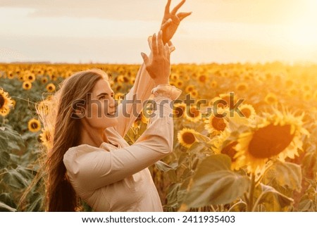 Woman in Sunflower Field: Happy girl in a straw hat posing in a vast field of sunflowers at sunset, enjoy taking picture outdoors for memories. Summer time.