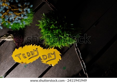 Teddy day greetings on wooden background with text space