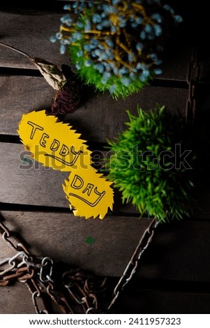 Teddy day greetings on wooden background with text space