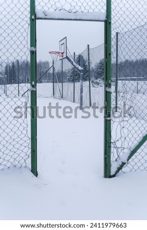 Outdoors basketball court covered with snow in winter, Finland.