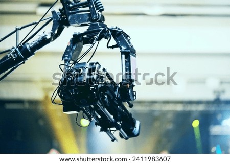 TV camera on a crane at a football match or concert. Close-up live video broadcast camera