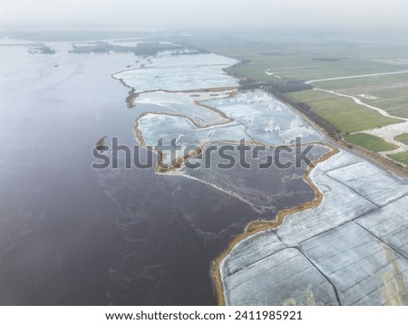 High quality aerial drone photo of people ice skating on a frozen lake in winter near Sneek, Friesland, the Netherlands
