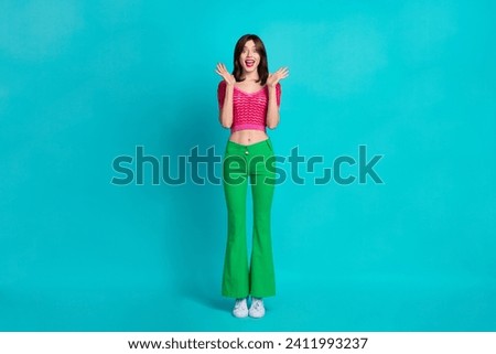 Full size photo of impressed overjoyed girl wear pink top raising palms up staring at awesome offer isolated on blue color background Royalty-Free Stock Photo #2411993237