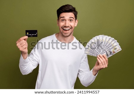 Photo of young funny business man finally withdraw his money after financial operations using ebanking isolated on khaki color background