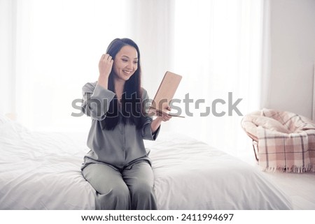 Photo portrait of attractive young woman hold mirror morning routine dressed stylish gray pajama isolated on white modern interior design