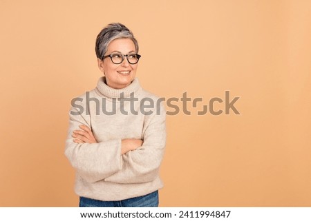 Portrait of confident business woman senior lady expert in sales management looking her interns ideas isolated on beige color background