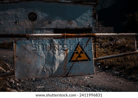 Old nuclear radioactive danger sign at the checkpoint Royalty-Free Stock Photo #2411996831