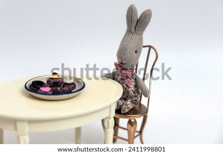 Kids toys. Set of toy furniture table with chairs. little bunny drinks tea. High quality photo