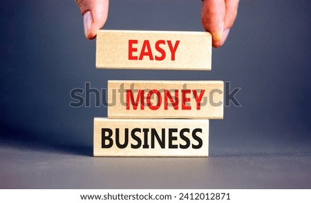 Easy money business symbol. Concept words Easy money business on beautiful wooden blocks. Beautiful grey table grey background. Businessman hand. Easy money business concept. Copy space.