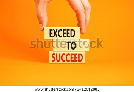 Exceed to succeed symbol. Concept words Exceed to succeed on beautiful wooden blocks. Beautiful orange table orange background. Businessman hand. Business and exceed to succeed concept. Copy space. Royalty-Free Stock Photo #2412012885