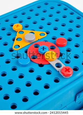 children's colorful plastic construction set, which includes an electric drill, screws, bolts and screwdrivers. various details and twisting. view from above.