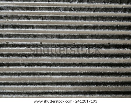 wavy patterned shop shutter made of sheet metal