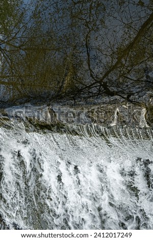 Cascading water over weir showing white foaming water