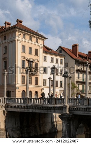Beautiful buildings along the promenade of the navigable Ljubljanica river in the city center of Ljubljana, Slovenia. Royalty-Free Stock Photo #2412022487