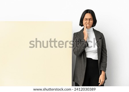 Young business mixed race woman with with a big banner over isolated background with toothache