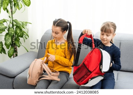 Two beautiful school girls with backpacks