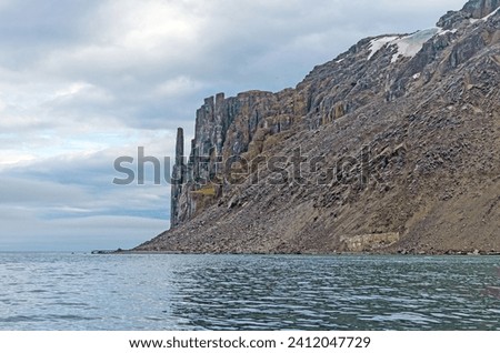 Lonely Rocks of Alkefjellet in the High Arctic of the Svalbard Islands  Royalty-Free Stock Photo #2412047729