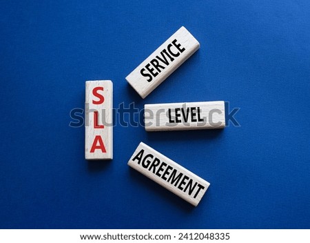 SLA - Service Level Agreement. Wooden blocks with word SLA. Beautiful deep blue background. Business and Service Level Agreement concept. Copy space.