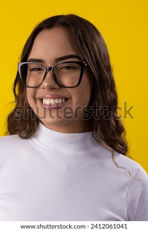 young woman wearing a white blouse and glasses on yellow background