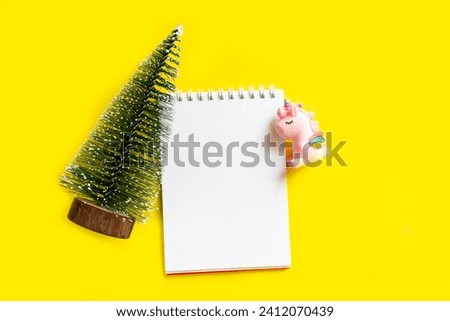 Workspace. Christmas letter. Spiral notepad and Christmas tree, unicorn. Top view with copy space, flat lay.