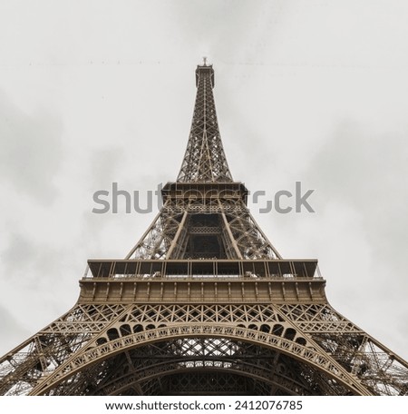 Low angle shot of Famous Eiffel tower iron structure with white sky background. Architectural detail design of the Eiffel tower in Paris. Paris Best Destinations in Europe, Copy space, Selective focus