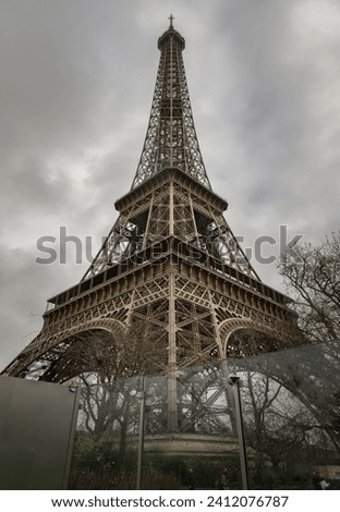 Low angle shot of Famous Eiffel tower iron structure with dark sky background. Architectural detail design of the Eiffel tower in Paris. Paris Best Destinations in Europe, Copy space, Selective focus.