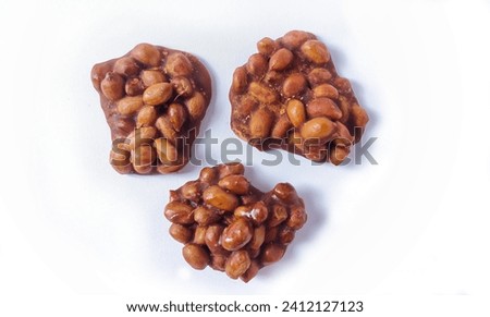 Top view of Ting-ting or Enting-enting or Ampyang isolated on white background. Traditional Indonesian sweet snack made from peanuts mixed with brown sugar. Clipping path.  Royalty-Free Stock Photo #2412127123