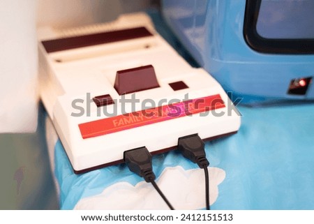 Close-up of an old game console, retro 80s games on a table.