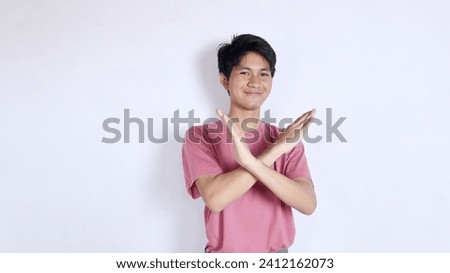 Stop. Concerned Asian man showing refusal sign, saying no, raising awareness, standing over white background