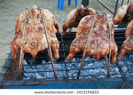 Close-up photo of chicken marinated in herbs Grilled on charcoal turtle, street food in Thailand