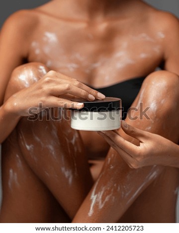 Young woman applied with moisturizing lotion cream on body