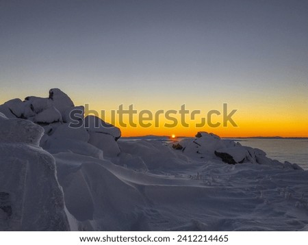 sunset view over a snowy mountain  Royalty-Free Stock Photo #2412214465