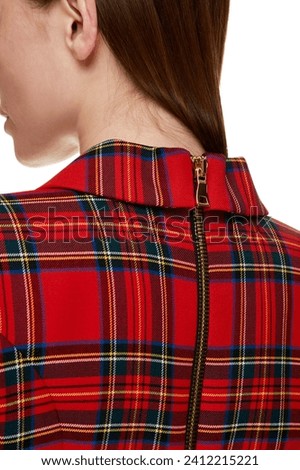 Close up detail of women's back view. Red plaid, tartan, striped clothes with  back zipper line on model isolated on white background. Neck to hem zipper. Fashion cloth concept. Template, mock up