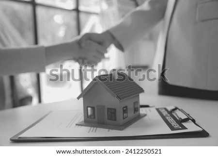 Real estate agent and customer signing contract to buy house, insurance or loan real estate.rent a house,get insurance or loan real estate or property.
