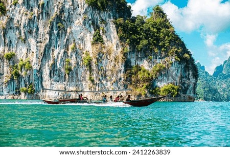 Khao Sok National Park, Surat Thani, 
Landscape Mountains with longtail boat for travelers, Cheow Lan lake, Ratchaphapha dam, Travel nature in Thailand, Asia summer  vacation travel trip.  Royalty-Free Stock Photo #2412263839