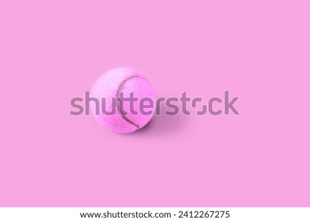 Pink tennis ball with shadow on a pink  background. Simple stop motion sport animation Royalty-Free Stock Photo #2412267275