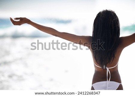 Black woman on beach in bikini, relax and stretching on holiday in waves, sunshine and travel from back. Sea, happiness and girl on ocean vacation in summer with adventure, peace and blue sky horizon
