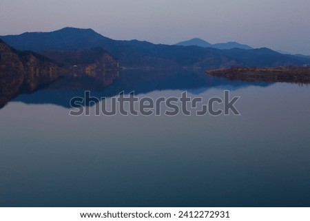 Sangju City, South Korea - March 9, 2017: As night deepens, the tranquil Nakdong River, viewed from Jungdong Bridge, presents a captivating scene with its shadowy riverbanks. Royalty-Free Stock Photo #2412272931