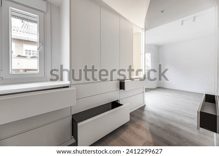 A dressing room in a recently renovated bedroom where at the moment there are only built-in wardrobes Royalty-Free Stock Photo #2412299627